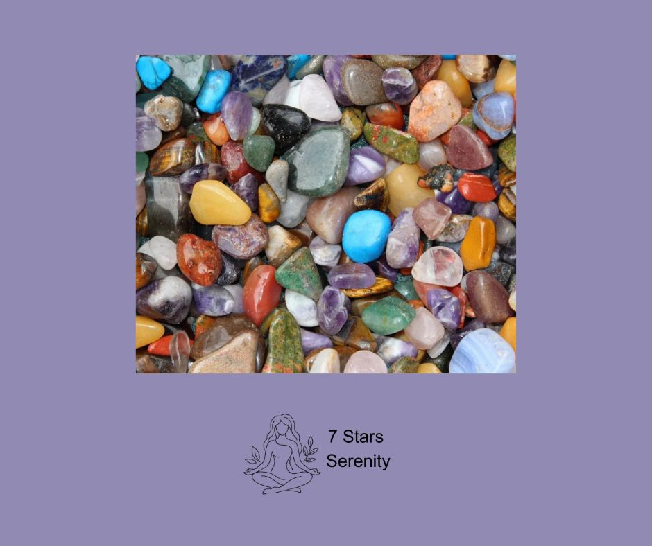 A collection of healing crystals including amethyst, rose quartz, and citrine arranged on a natural surface